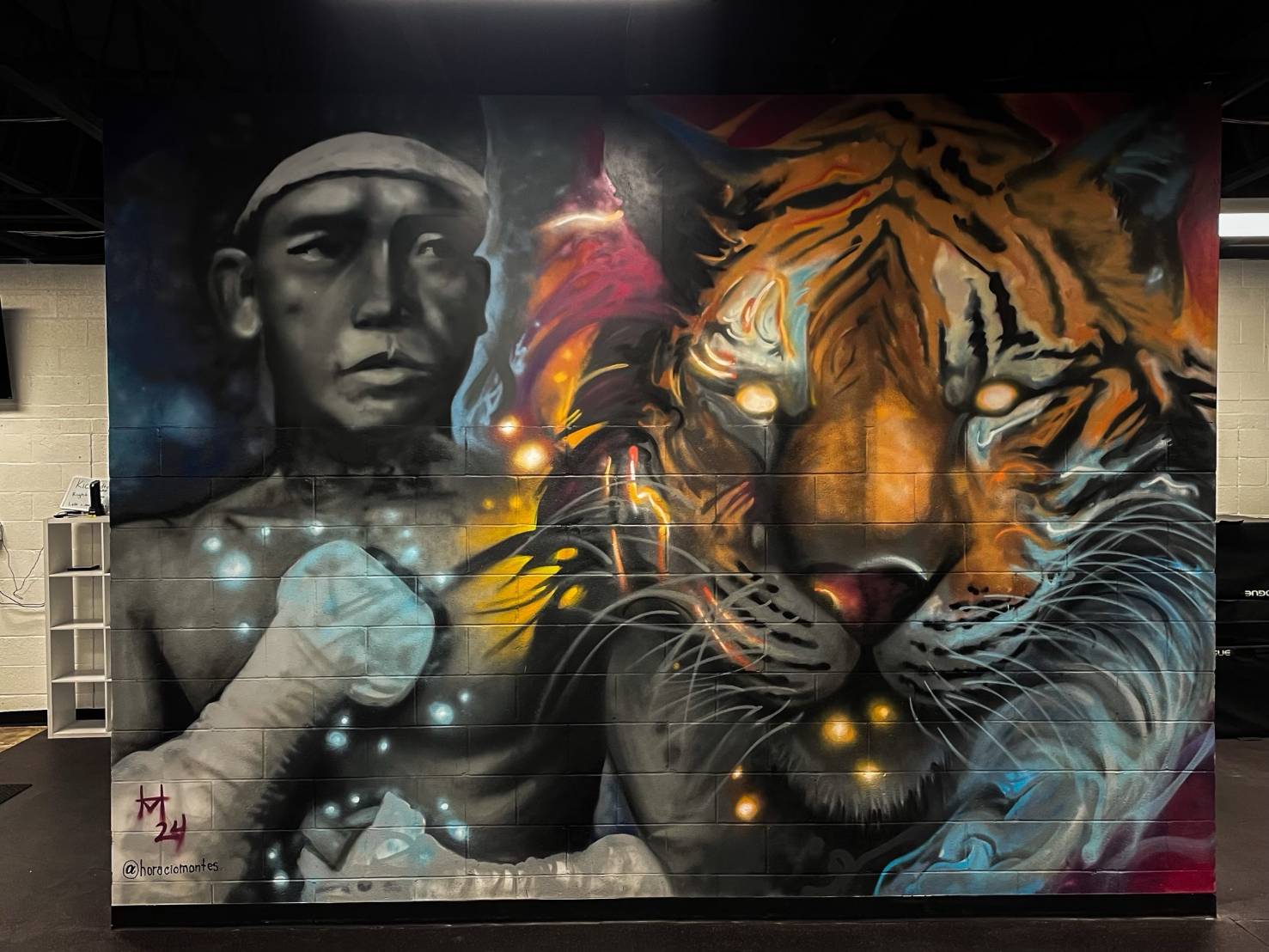 Gym mural featuring fighter and tiger artwork